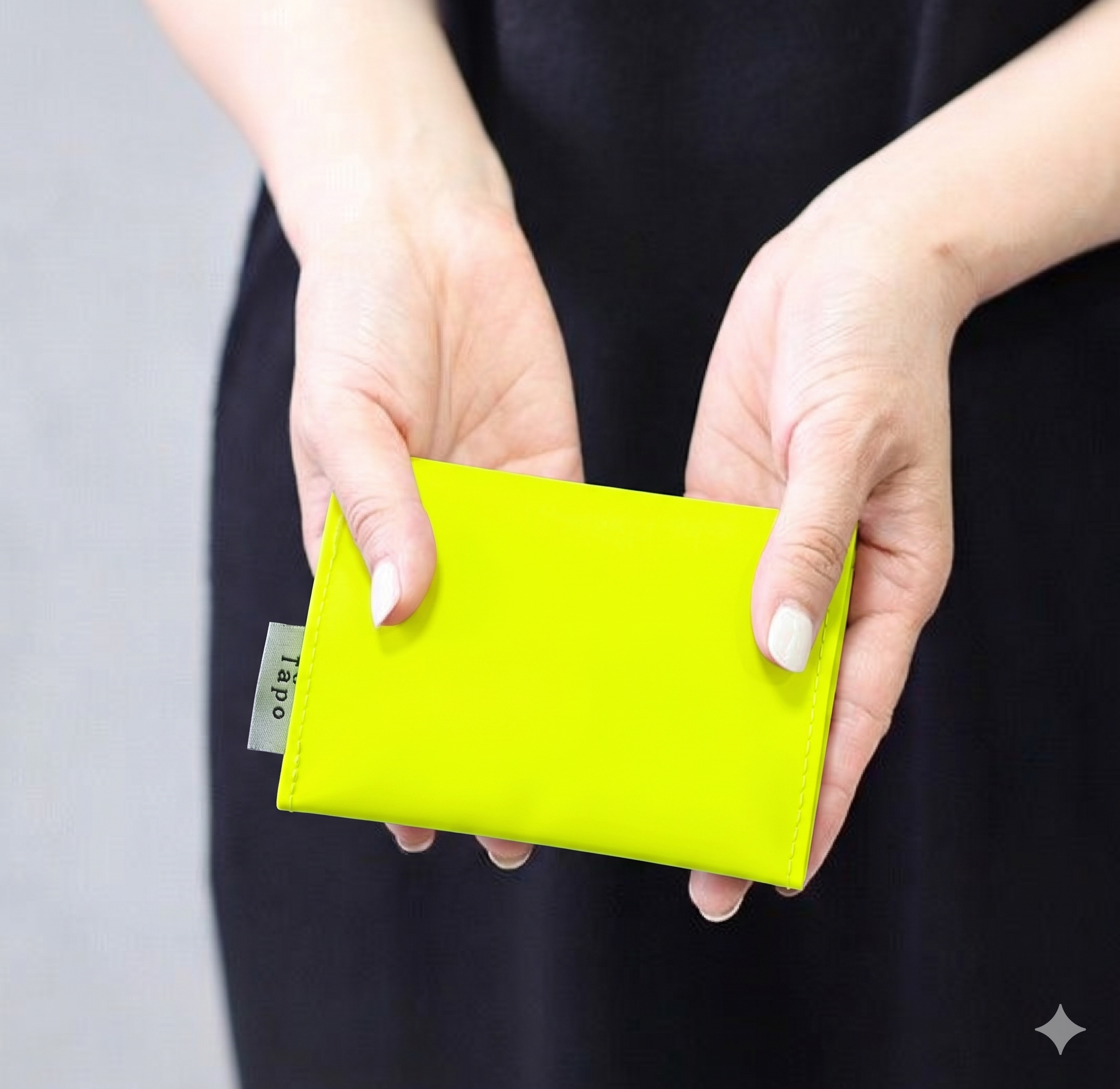 ta-po neon yellow wallet held by hands
